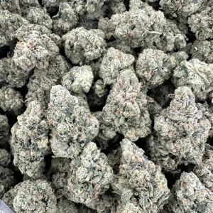 Kami Kush loud flower close-up showing packed buds frosted with trichomes in sage-green and silvery-white throughout